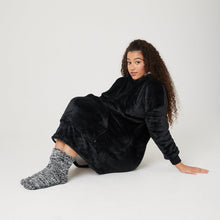Load image into Gallery viewer, Black hooded blanket for kids sat down with oversized hoodie over knees
